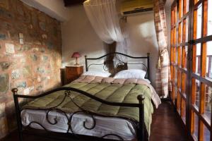 a bedroom with a bed in a room with windows at Ferienhaus In Mavrikiano Mit Privatem Pool in Elounda