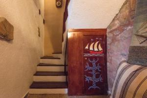 a hallway with a stairway with a door and stairs at Ferienhaus In Mavrikiano Mit Privatem Pool in Elounda +24 photos