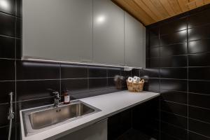 a bathroom with a sink and a mirror at Penthouse Serena Tampere in Tampere