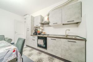 a kitchen with white cabinets and a sink at Casa Francesco - close to the airport & private parking in Azzano San Paolo