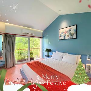 a bedroom with a christmas tree and a bed at Joi Home Beachfront in Vung Tau