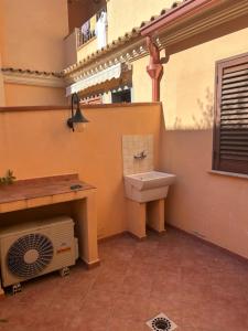 a bathroom with a sink and a fan at Le Mille e Una Notte II in Olbia