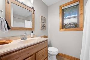 a bathroom with a sink and a toilet and a mirror at Vista View in Sugar Grove +68 photos