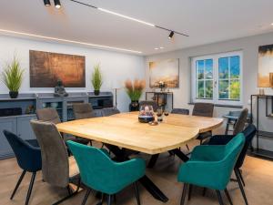 a dining room with a wooden table and chairs at Waldklang Panorama in Alpirsbach