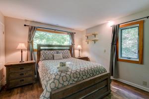 a bedroom with a large bed and a window at Paws A While in Blowing Rock