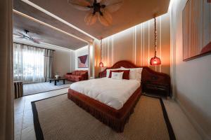 a bedroom with a bed and a ceiling fan at Casa Fontana in Alaçatı