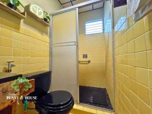a bathroom with a black toilet and a shower at Penny House Hostal in David +28 photos