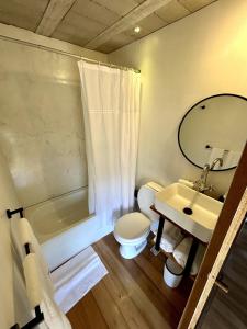 a bathroom with a sink and a toilet and a tub at Pedre Loft in La Pedrera +25 photos