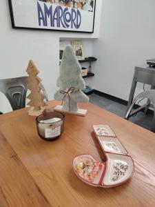 a table with a stuffed animal and a toy christmas tree at Casa del Mercante in centro ad Asti no ztl in Asti