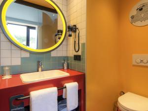 a bathroom with a sink and a mirror at ibis Styles Tbilisi Center in Tbilisi City +113 photos