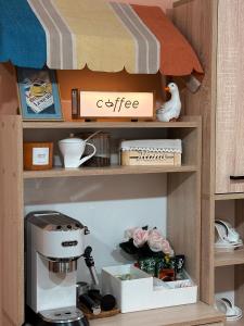 a cupboard with a coffee machine in a kitchen at Lilia's Cozy Duplex In The City Center in Yerevan