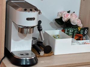 a mixer sitting on a counter next to a box at Lilia's Cozy Duplex In The City Center in Yerevan