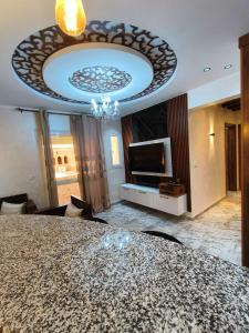 a living room with a large bed and a television at Dar El Ommda in Tozeur