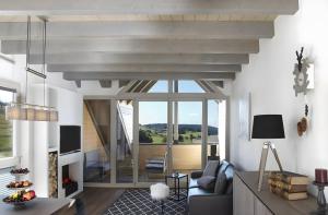 a living room with a couch and a table at Panorama Atemlos Kuckucks Chillout in Oberibach