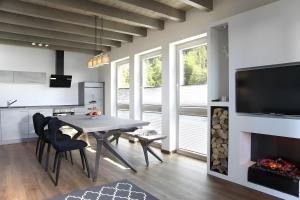 a kitchen and dining room with a table and a fireplace at Panorama Atemlos Kuckucks Chillout in Oberibach