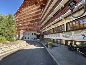 a building with a motorcycle parked in front of it at Appartement rénové au cœur de Méribel, proche des pistes - FR-1-355-108 in Méribel +6 photos