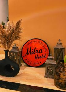 a sign for a mittoria hotel sitting on a table at Mitra Palolem in Canacona