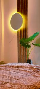 a bedroom with a bed with a lamp and a plant at Mitra Palolem in Canacona