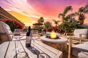 a table with wine glasses and a fire pit at Luxurious Custom-built Villa Pool Spa Fire Pit more in Palm Desert +66 photos