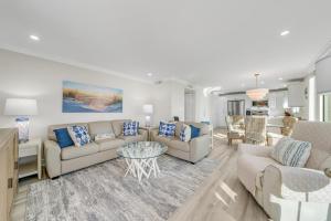 a living room with a couch and a table at Island Beach Club #320E in Sanibel