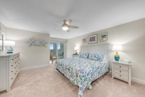a bedroom with a bed and a ceiling fan at Island Beach Club #320E in Sanibel +43 photos