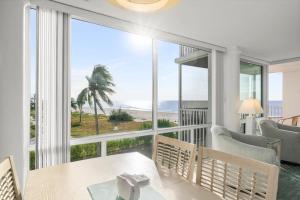 a dining room with a view of the ocean at Island Beach Club #340E in Sanibel