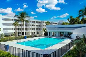 an image of a swimming pool in front of a building at Island Beach Club #340E in Sanibel