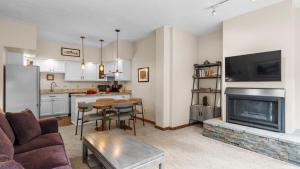 a living room with a couch and a fireplace at Ghostriders 2 by AvantStay Tidy Unit Close to the Slopes and Shops in Telluride +5 photos