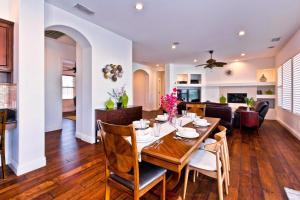 a dining room and living room with a table and chairs at Poolside Bliss with elegant living #1 Rated in Palm Desert