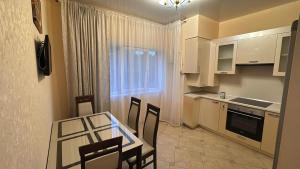 a kitchen with a table and chairs and a window at Wohnung Alter Hof in Künzell