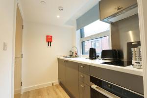 a kitchen with a sink and a stove at Studio Flat Close to Queen Square - Flat 5A in Bristol