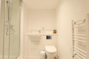 a white bathroom with a toilet and a shower at Studio Flat Close to Queen Square - Flat 5A in Bristol
