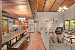 a living room with a large wooden table and chairs at Banner Elk Lodge in Beech Mountain