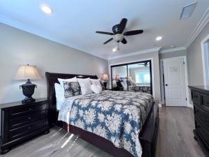 a bedroom with a bed and a ceiling fan at Destination #32 in Anaheim +25 photos