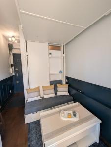 a living room with a couch and a table at The suspended cocoon in Le Havre