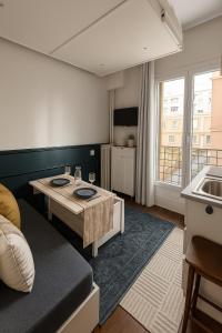a living room with a couch and a table at The suspended cocoon in Le Havre