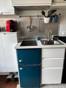 a small kitchen with a sink and a sink at The suspended cocoon in Le Havre