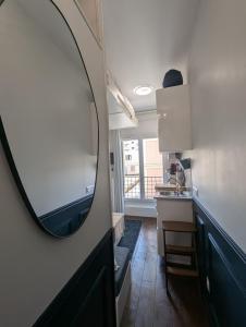 a room with a mirror and a kitchen with a window at The suspended cocoon in Le Havre +9 photos