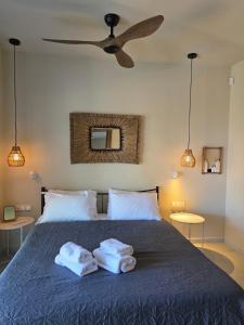 a bedroom with a bed with two towels on it at Rastoni Suites Xylokastro 1 in Melission
