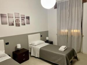 Ένα ή περισσότερα κρεβάτια σε δωμάτιο στο Domus Pellicciai