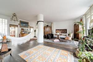 a living room with a fireplace and a living room with a rug at Camera con bagno privato e terrazzo a 10 minuti dalla Stazione Centrale - Oasis Bologna Centro in Bologna
