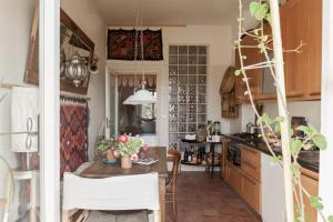 a kitchen with a table and a dining room at Camera con bagno privato e terrazzo a 10 minuti dalla Stazione Centrale - Oasis Bologna Centro in Bologna