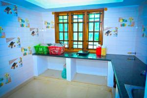 a bathroom with a counter with baskets on it at Green Palaces Homestay in Avathi