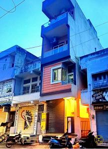 a building with a motorcycle parked in front of it at Homestay Chittor Inn in Chittaurgarh