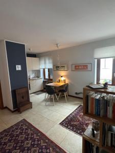 a living room with a table and a kitchen at Cormòns 2# in Cormòns