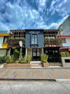 a building with a hotel sign on the front of it at Urbano Luxury Hotel in Pasto
