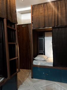 a room with a bunk bed and a ladder at Mosaic Hostel Varanasi in Varanasi