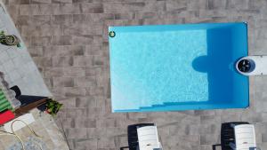 a swimming pool with a puzzle piece on the wall at Gîte Soleil Canne in Capesterre