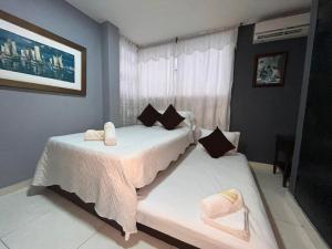 two beds in a bedroom with a window at Aloha Rodadero in Gaira +11 photos