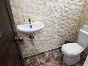 a bathroom with a sink and a toilet at Finca la Albania in Circasia +24 photos